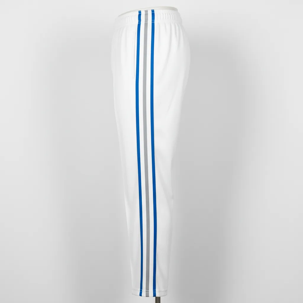Side view of custom piped softball pants showing the full-length contrast piping down the outer leg seam
